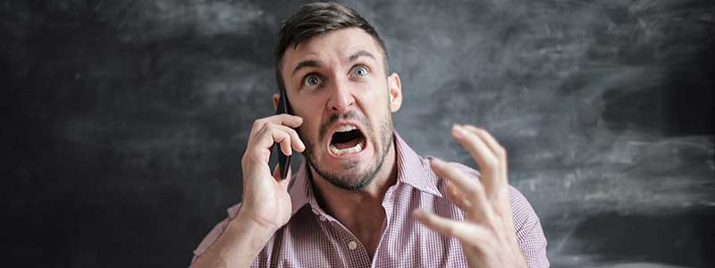 angry young man on the phone with customer service