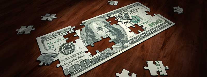 US One-Hundred Dollar Bill in Puzzle Pieces - Solving the Puzzle of Business Analytics