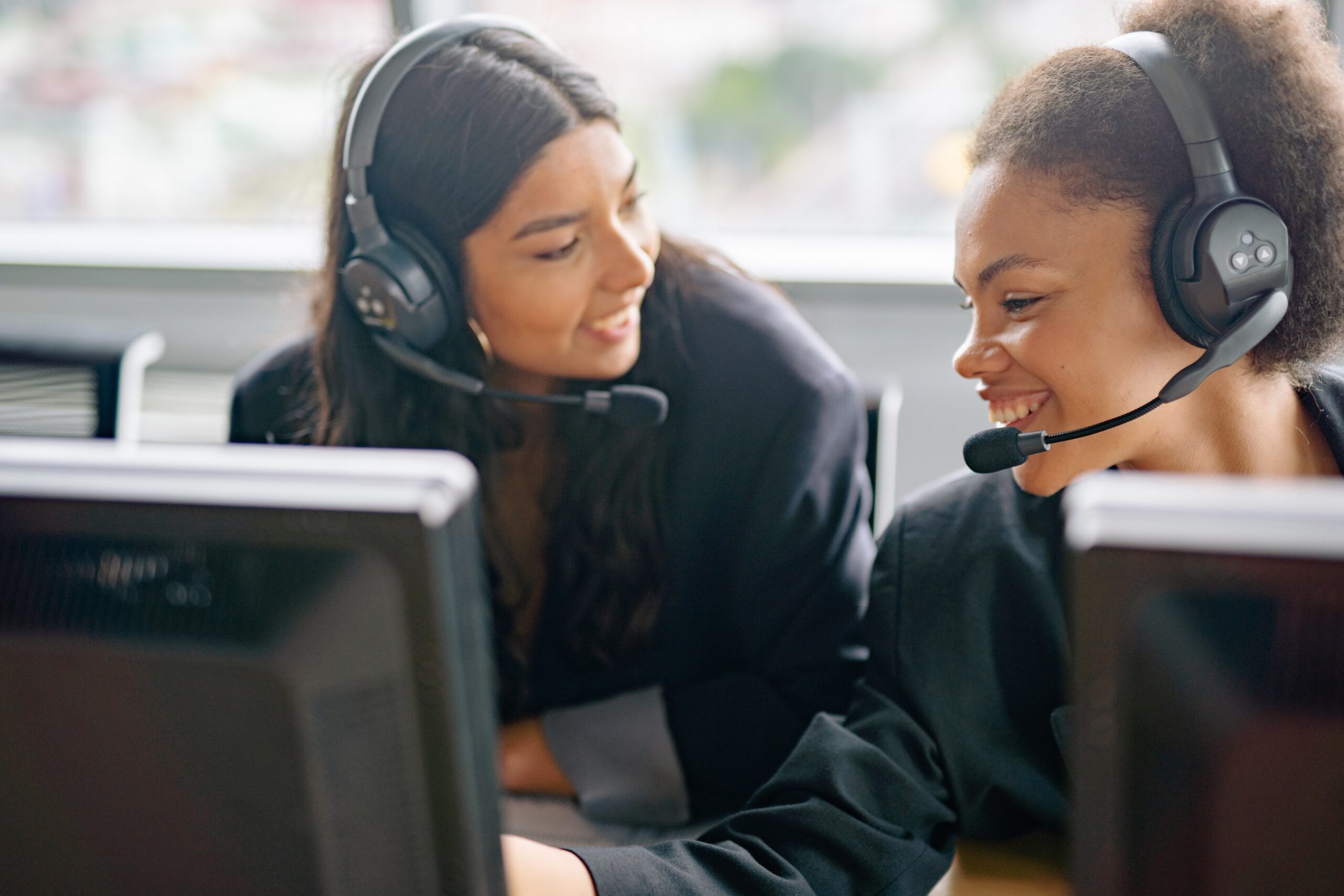 two women working in a drug rehab call center using call center analytics